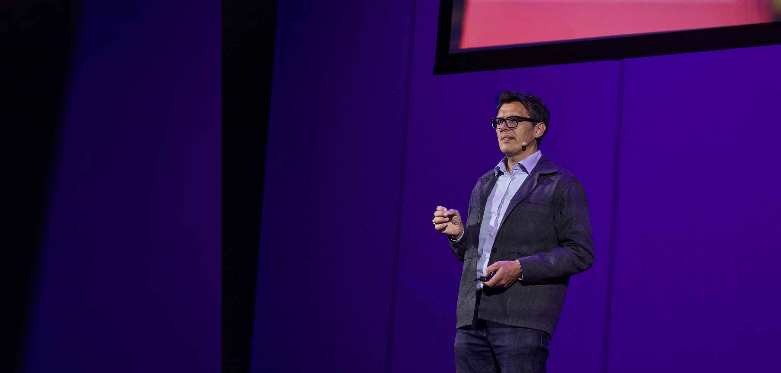 Keynote speaker addressing an executive audience on stage